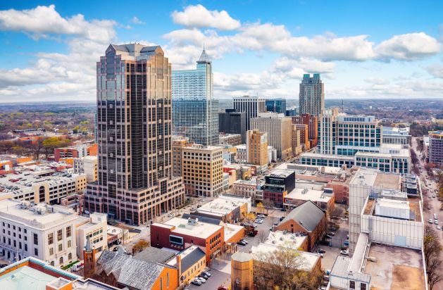 Aerial view of downtown Raleigh, NC skyline with high-rise buildings near Madison Laurel Oaks apartments